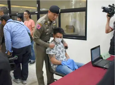  ??  ?? The alleged mastermind being brought to the Thai police headquarte­rs. — Bernama photo