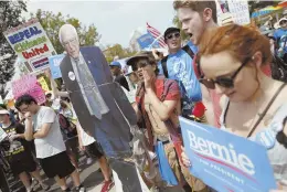  ?? AP PHOTO ?? WON’T BACK DOWN: Supporters of Bernie Sanders marched in downtown Philadelph­ia yesterday. Despite his call for them to back Hillary Clinton, the die-hards refuse to go quietly.