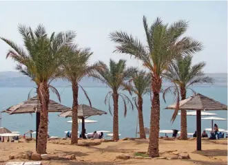  ??  ?? Photo shows Amman Beach on Jordan's shore of the Dead Sea, which is actually a spectacula­r lake 1,400 feet (400 meters) below sea level.