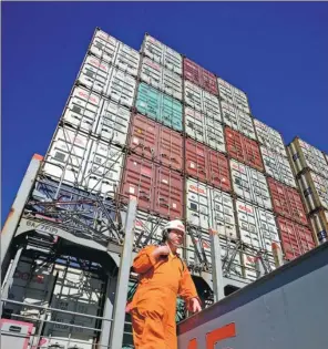 ?? BLOOMBERG ?? A crewman onboard the a container ship of Orient Overseas Container Line, a subsidiary of OOIL, on the main deck at the Modern Terminals area of the container port in Hong Kong.