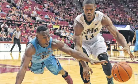  ?? FLORIDA STATE ATHLETICS ?? In this Nov. 17, 2015 file photo, Montay Brandon of the Florida State Seminoles dives for the ball in front of Marcel White (13) of the University of Jacksonvil­le Dolphins during NCAA basketball play. Brandon signed with the St. John’s Tuesday, becoming the fourth player on the team’s roster as it prepares for the 2019-20 National Basketball League of Canada season.