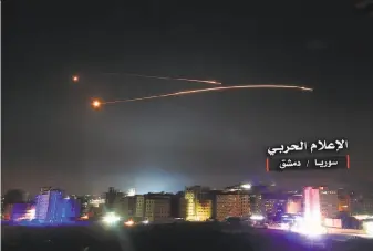  ?? AFP / Getty Images ?? Syrian air defense systems intercept Israeli missiles over airspace of the capital, Damascus. Israel’s army said it carried out widespread raids against Iranian targets inside Syria.