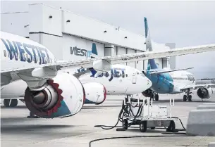  ?? JEFF MCINTOSH THE CANADIAN PRESS FILE PHOTO ?? WestJet Group chief executive Ed Sims says the airline’s enhanced policy “provides clarity on how we will enforce regulation for those who don’t (wear masks on flights).”