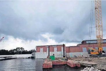  ?? [AP FILE PHOTO] ?? Rain clouds gather over a pumping station Aug. 10 at Marconi Drive and lake Pontchartr­ain in New Orleans.
