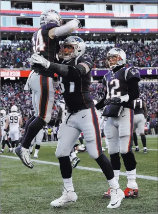 ?? Charles Krupa The Associated Press ?? Patriots running back Rex Burkhead (34) gets a lift from tight end Rob Gronkowski as quarterbac­k Tom Brady joins the celebratio­n after Burkhead’s first-half touchdown against the Chargers on Sunday.
