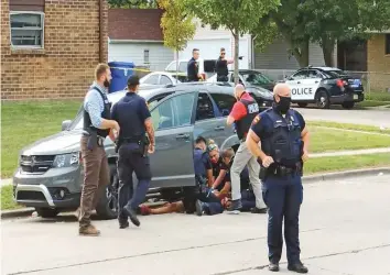  ?? Reuters ?? ■
Father-of-three, Jacob Blake lies on the street after he got shot by policemen in Kenosha, Wisconsin on August 23 in this screen grab obtained from a social media video.