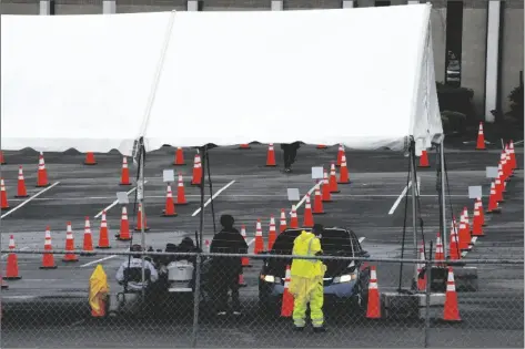  ?? JAY REEVES/AP ?? WORKERS AT A MOSTLY EMPTY COVID-19 VACCINATIO­N CLINIC Birmingham, Ala., are shown on Monday. located at Cathedral of the Cross A.O.H. Church of God in