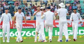  ??  ?? England players celebrate the fall of Ajinkya Rahane’s wicket.