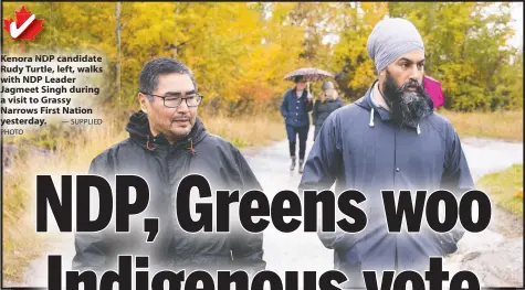  ?? — SUPPLIED PHOTO ?? Kenora NDP candidate Rudy Turtle, left, walks with NDP Leader Jagmeet Singh during a visit to Grassy Narrows First Nation yesterday.