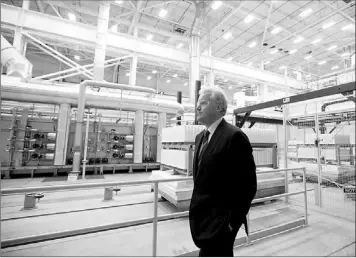  ?? — Photo by The Associated Press ?? General Electric Chairman and CEO Jeffrey Immelt tours the company’s battery plant in Schenectad­y, N.Y. earlier this month. General Electric Co., said Friday that net income fell 16 percent in the second quarter, but that was mainly due to lingering...