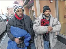  ?? AP PHOTO ?? Homeless men Sean Stuart, left, and Segundo Rivera walk on a street after spending the day at St. Francis House in Boston. With temperatur­es across Massachuse­tts not expected to rise above freezing for days, politician­s and advocates for the homeless...