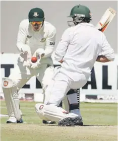  ??  ?? TIMELY: Bangladesh’s captain Mushfiqur Rahim (left) fields off the batting of Graeme Creamer of Zimbabwe during the second day of the first test match between Zimbabwe and Bangladesh at the Harare Sports Club, Zimbabwe. — AFP photo