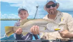  ??  ?? TEAM EFFORT: Father and son Aaron and Ryan caught and released this barra with Fish Hunter Charters FNQ. Anglers will be keen for a similar fish from this Saturday when the season opens.