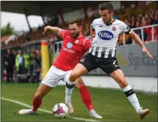  ??  ?? Kyle Callan-McFadden goes up against Dundalk’s Michael Duffy during last Monday’s defeat to the Lilywhites at the Showground­s.