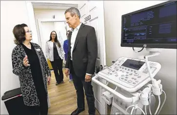  ?? Mark Zaleski Associated Press ?? LAURA MESSICK shows Tennessee Gov. Bill Lee one of two ultrasound exam rooms at a crisis pregnancy center in Murfreesbo­ro. The state is one of about a dozen that have given taxpayer money to such centers.