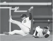  ?? DUANE BURLESON/GETTY IMAGES ?? Shortstop Jose Iglesias of the Detroit Tigers collides with Victor Reyes during action at Comerica Park Sunday.