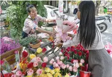  ?? ?? A woman buys flowers on Valentine’s Day in Phnom Penh.