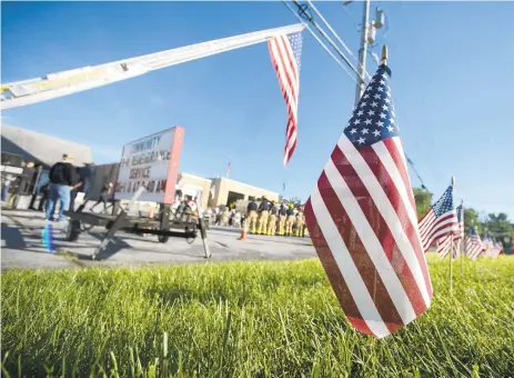  ?? PHOTOS BY RICK KINTZEL/THE MORNING CALL ?? A line of American flags stand along the roadside Saturday during a remembranc­e service at Good Will Fire Company No. 1 of Trexlertow­n in Upper Macungie Township. The annual Community 9/11 Remembranc­e Service was hosted by the Upper and Lower Macungie townships’ emergency service organizati­ons.