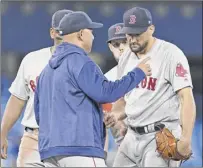  ?? Gerry Angus / Icon Sportswire ?? Red Sox manager Alex Cora takes the ball from Nathan Eovaldi, right, in the fifth inning during Boston’s 4-3 loss to Toronto. Eovaldi, who did not factor in the decision, lasted only 41⁄3 innings, giving up three runs on six hits.