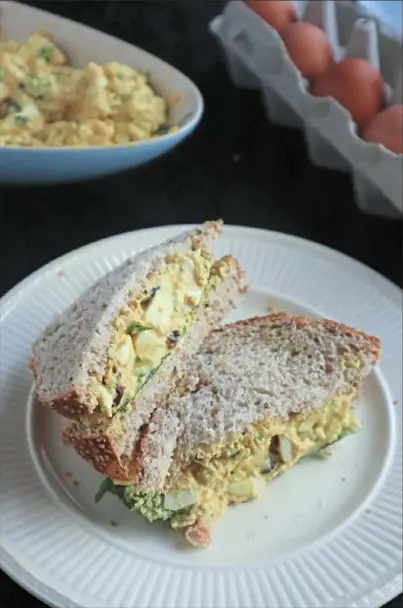  ?? Gretchen McKay/Post-Gazette ?? Curried egg salad, made with Greek yogurt, raisins and green onion, can be stuffed into a sandwich or piled on top of salad greens.