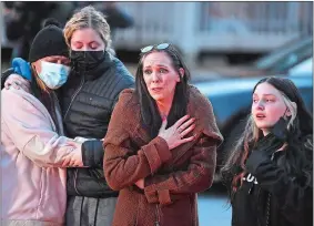  ?? SARAH GORDON/THE DAY ?? Close friend Jen Ostby, center, speaks Monday as she is surrounded by, from left, Crystal Chilleri, Remedy Jones and Trinity Empie-Jones during a vigil for 4-year-old David Jasmin in the parking lot of the Nautilus Drive apartment complex where he lived.