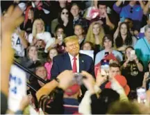  ?? MEG KINNARD/AP ?? Republican presidenti­al candidate and former President Donald Trump interacts with supporters after speaking during a rally in the closing weeks ahead of South Carolina’s Republican presidenti­al primary Feb. 10 in Conway, South Carolina.