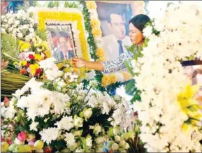  ?? PHA LINA ?? A supporter lights incense to pay respects to the slain political analyst Kem Ley at a ceremony commemorat­ing the first anniversar­y of his murder last July.