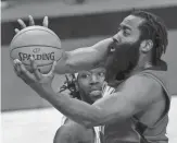  ?? POOL PHOTO/USA TODAY SPORTS ?? The Rockets’ James Harden, right, puts up a shot during the third quarter against the Lakers on Sunday.