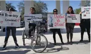  ??  ?? Eliza Cameron and several other Midwestern State University students (top) march in protest of President-elect Donald Trump in Wichita Falls, Texas, on Wednesday. Demonstrat­ors rally in front of Homestead City Hall, Florida. — AP, AFP