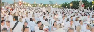  ??  ?? The Dîner en Blanc event in Paris attracted 15,000 people to dine in front of Notre Dame Cathedral.