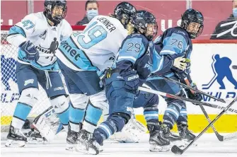  ?? DAVE HOLLAND • PWHPA ?? Team Bauer’s Marie-Philip Poulin (29) and Karell Emard (76), and Team Sonnet’s Brianne Jenner (19) and Jamie Lee Rattray (47) battle for position during the PWHPA Secret Dream Gap Tour Calgary tournament final at the Saddledome on Sunday.
