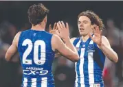  ?? Picture: GETTY ?? ON FIRE: Ben Brown (3 goals) celebrates with Nick Larkey (5 goals) in Hobart.