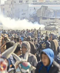  ?? AFP ?? An Israeli tank rolls along a position as Palestinia­ns flee Khan Yunis in the southern Gaza Strip on Saturday.