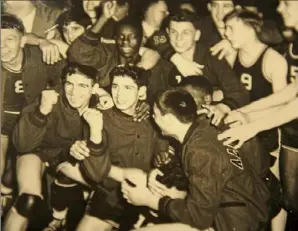  ?? Photos courtesy of Sharon Danovich Lupone ?? George Danovich, first row left, celebrates with his teammates after winning the Class A state basketball championsh­ip in 1949.