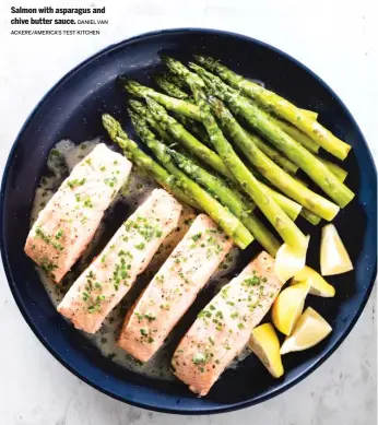  ?? DANIEL VAN ACKERE/AMERICA’S TEST KITCHEN ?? Salmon with asparagus and chive butter sauce.