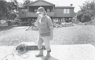  ?? Steve Gonzales / Houston Chronicle ?? Jennifer Harpster at her Channelvie­w home near a toxic waste pit. Harpster worried about toxins in her home after floodwater entered the house, which stands on 8-foot stilts.