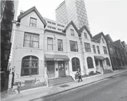  ?? RICHARD LAUTENS/TORONTO STAR ?? Chris Morgan bought the townhouses in 1997 with his late father John, a comic and writer on CBC’s Royal Canadian Air Farce. The hostel had only two beds in 1999.