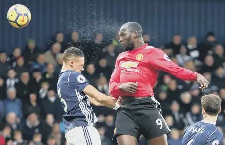  ??  ?? Powerful striker Romelu Lukaku rises to head home Manchester United’s opening goal at The Hawthorns yesterday.