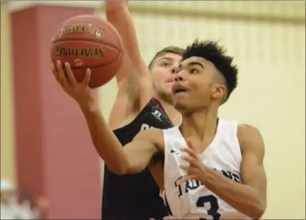  ?? THOMAS NASH - DIGITAL FIRST MEDIA ?? Pottstown’s Floyd Dashiell (3) goes up for a bucket over a Chichester defender during the first half of Friday night’s game.