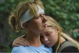  ?? DAVID GOLDMAN/AP ?? Nelia Fedorova, left, and daughter Yelyzaveta Gavenko, 11, embrace as they visit a neighbor’s home Saturday where someone was killed in a Russian rocket attack that also injured Fedorova, in Kramatorsk, Ukraine. The Ukrainian military has slowed Russia’s advance.