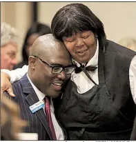  ?? Arkansas Democrat-Gazette/STATON BREIDENTHA­L ?? Little Rock Mayor-elect Frank Scott Jr. gets a congratula­tory hug Wednesday from Renee Goynes, banquet captain at the Wyndham Riverfront Hotel in North Little Rock, during the Urban League of Arkansas’ Whitney M. Young Jr. Awards luncheon.