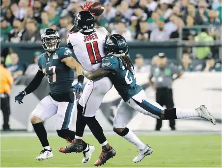  ?? THE ASSOCIATED PRESS ?? Atlanta Falcons’ Julio Jones misses a pass between Philadelph­ia Eagles’ Nate Gerry, left, and Ronald Darby.