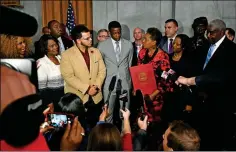  ?? ASSOCIATED PRESS ?? JAMES SHAW JR., WHO WAS INJURED when he disarmed a shooter inside a Nashville-area Waffle House, stands with family and friends at a press conference after he was honored at the Tennessee State House Tuesday, April 24, 2018, in Nashville, Tenn.