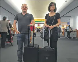  ?? Scott Mayerowitz / Associated Press ?? Associated Press journalist­s Scott Mayerowitz and Candice Choi wait at New York’s LaGuardia Airport. They were traveling together to compare the experience­s of travelers with elite status and those without.