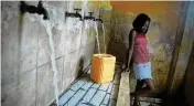  ?? ODELYN JOSEPH / ASSOCIATED PRESS ?? A resident, without running water at home, fills a container at a water fill station in Port-au-prince, Haiti, on Tuesday.