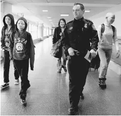  ??  ?? Supervisor­y officer Huss (second right) for US Customs and Border Protection escorts; Emmanuel Rutema, Mwigulu Magesa, Elissa Montanti, founder of the Global Medical Relief Fund and Pendo Noni,(left to right) following their arrival at JFK...