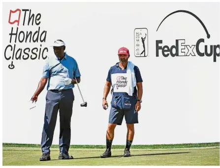  ?? — Reuters ?? Vintage golf: Vijay Singh (left) talks to his caddie Danny Sahl on the ninth green during the third round of the Honda Classic golf tournament at the PGA National on Saturday.