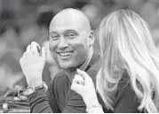  ?? Joe Skipper / Associated Press ?? Derek Jeter was jeered while at a Miami Heat game with his wife, Hannah Davis.