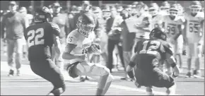  ?? HERALD Photo/courtesy Photo ?? Above left: The Coahoma Bulldogs head onto the field for their game against Abernathy. Above right: Noah Dials, who started for the injured Kolt Redden at quarterbac­k, tries to make his way through two potential tacklers.