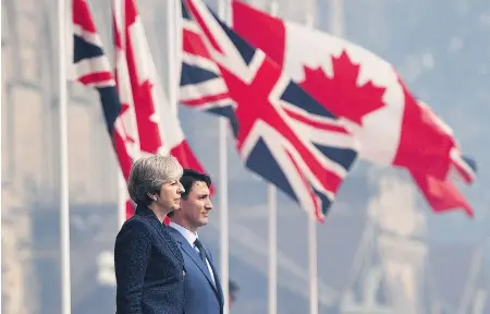  ?? SEAN KILPATRICK / THE CANADIAN PRESS ?? British Prime Minister Theresa May is greeted by Prime Minister Justin Trudeau as she arrives to Parliament Hill in Ottawa on Monday. The leaders confirmed they are working toward a new bilateral free trade deal to take effect after the U.K. achieves...